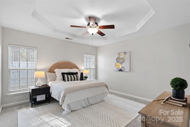 bedroom with a raised ceiling, ornamental molding, carpet, and ceiling fan