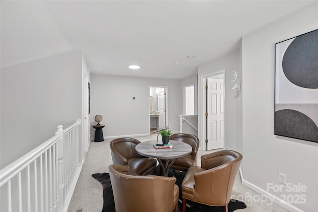 dining room with light colored carpet