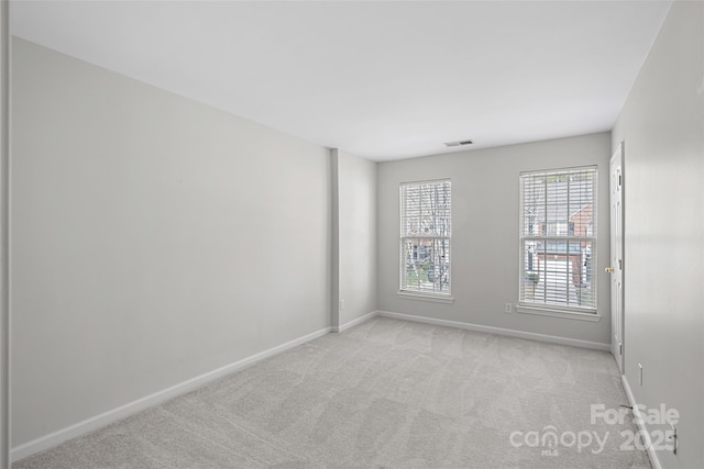 empty room featuring light colored carpet