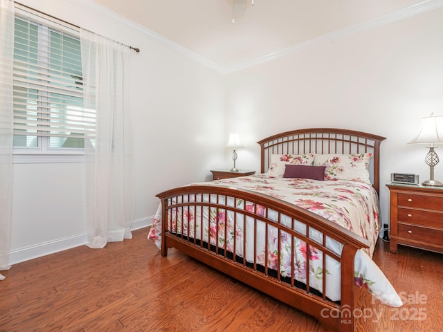 bedroom with wood-type flooring and ornamental molding