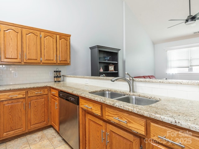 kitchen with dishwasher, lofted ceiling, sink, decorative backsplash, and light stone countertops