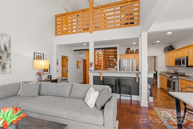 living room featuring a towering ceiling