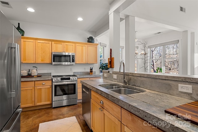 kitchen featuring appliances with stainless steel finishes, a chandelier, and sink