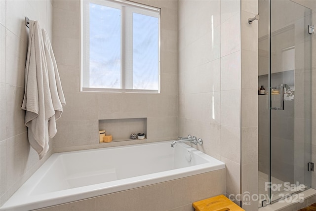 bathroom with separate shower and tub