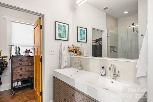 bathroom featuring tasteful backsplash, vanity, and an enclosed shower