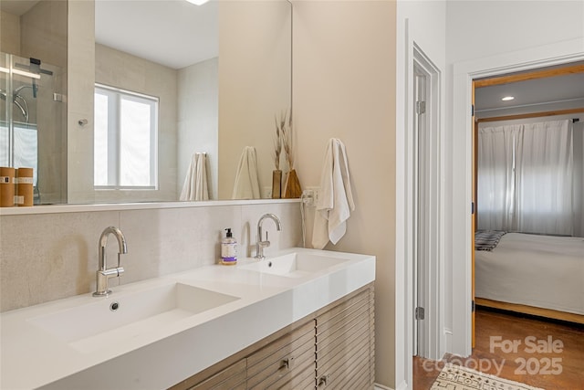 bathroom featuring vanity and decorative backsplash