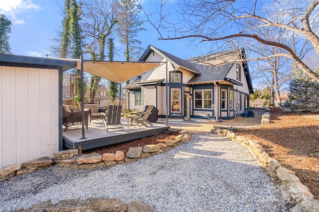 rear view of property with an outdoor hangout area and a deck