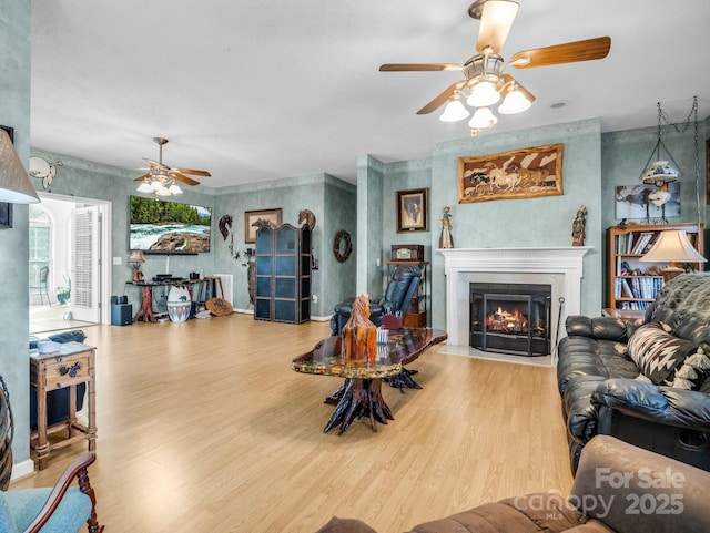 living room featuring wood-type flooring and ceiling fan