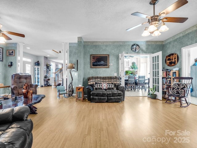 living room with ceiling fan and light hardwood / wood-style floors