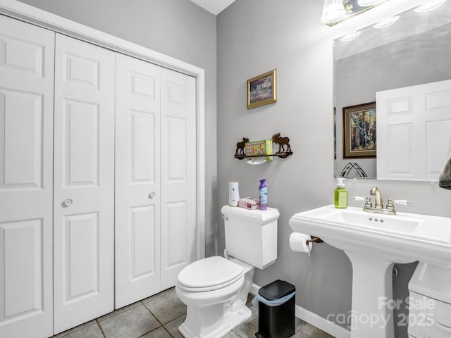 bathroom featuring tile patterned flooring, sink, and toilet