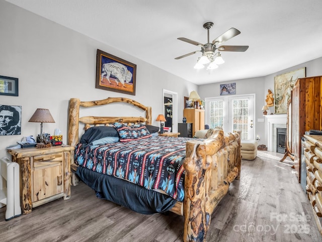 bedroom featuring ceiling fan, hardwood / wood-style floors, and access to outside