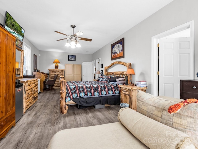 bedroom featuring hardwood / wood-style flooring, ceiling fan, and refrigerator