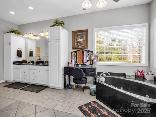 bathroom featuring vanity, a bath, and tile patterned floors