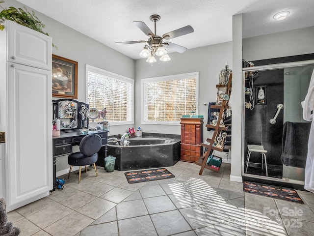 bathroom featuring ceiling fan, shower with separate bathtub, tile patterned floors, and a textured ceiling