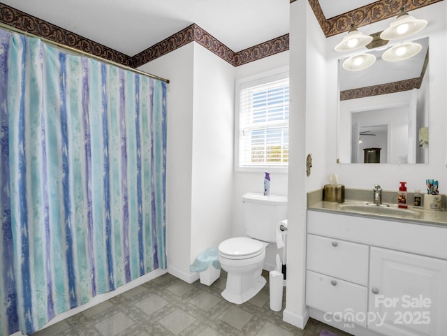 bathroom with vanity, toilet, and curtained shower