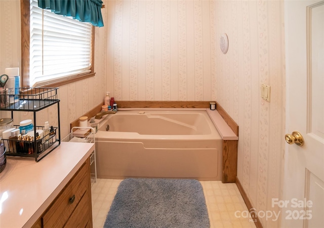 bathroom with a washtub and vanity