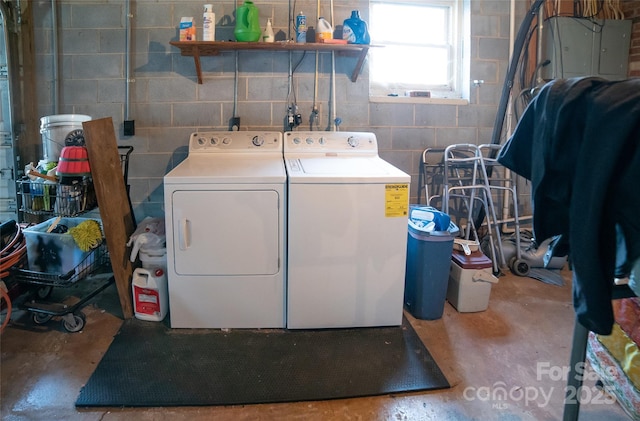 clothes washing area with electric panel and washing machine and dryer