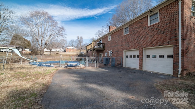 view of property exterior with a balcony and a garage