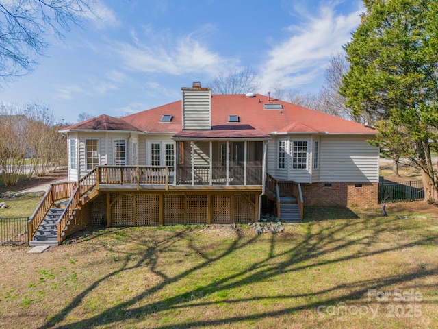 back of house featuring a lawn, fence, stairs, and a sunroom