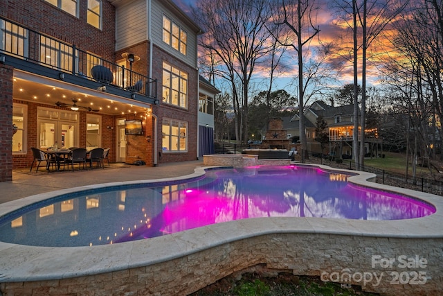 outdoor pool with a patio area