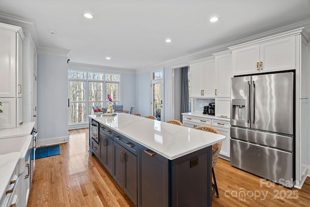 kitchen with white cabinets and stainless steel fridge with ice dispenser