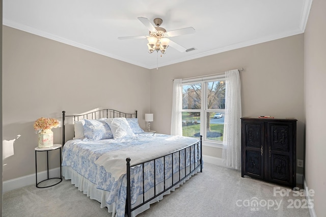 bedroom featuring baseboards, ornamental molding, visible vents, and light colored carpet