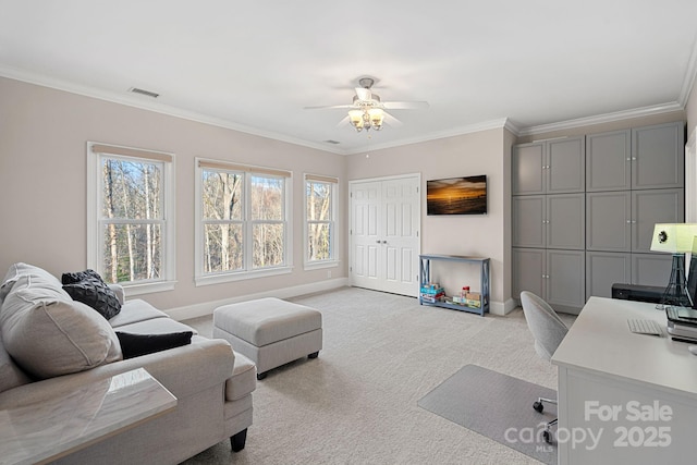 home office featuring light colored carpet, visible vents, ornamental molding, a ceiling fan, and baseboards