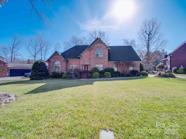 front facade featuring a garage and a front lawn