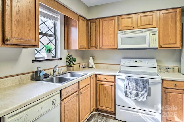 kitchen featuring white appliances and sink