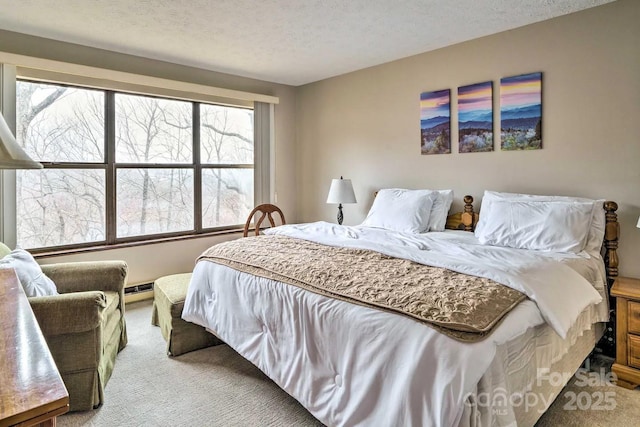 bedroom with light carpet, a baseboard radiator, and a textured ceiling