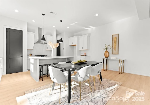 dining space featuring light wood-type flooring