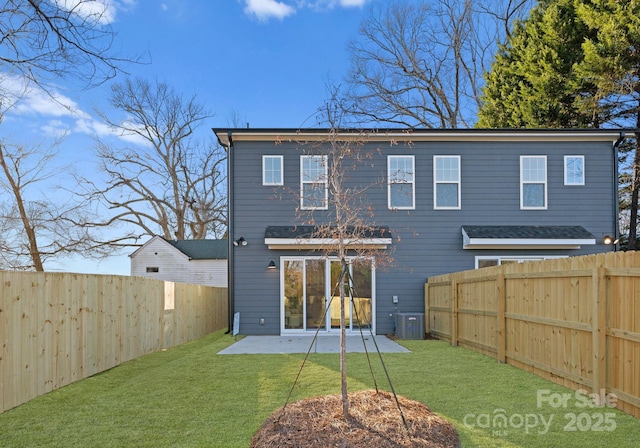 back of house featuring a patio area, a lawn, and central AC unit