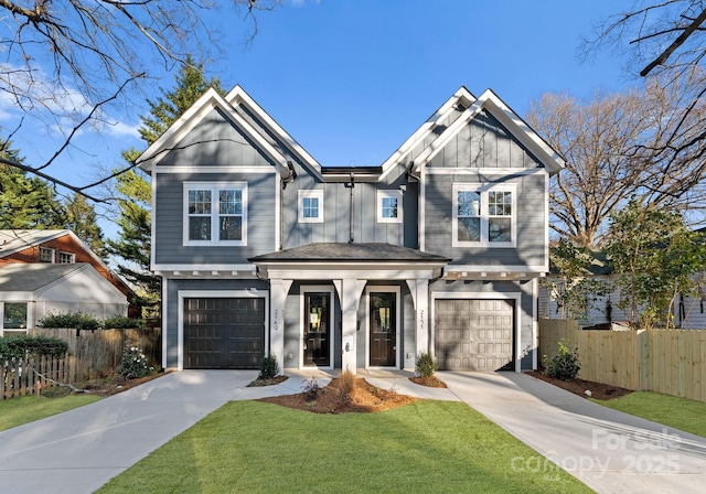 craftsman house with a front lawn and a garage