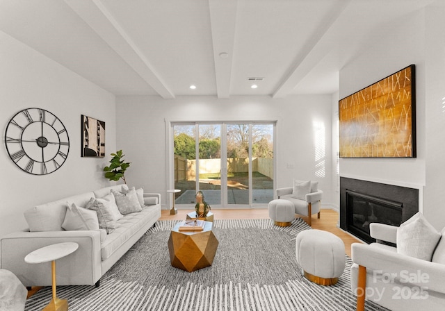 living room with beam ceiling and hardwood / wood-style floors