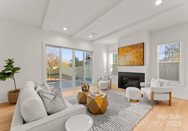 living room featuring hardwood / wood-style flooring and beam ceiling