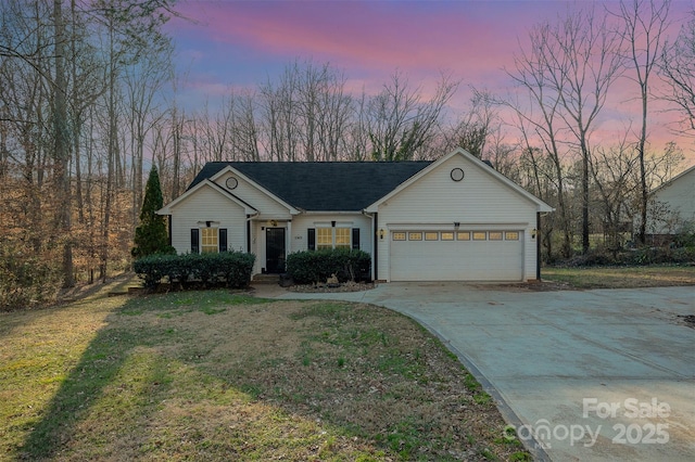 single story home featuring a garage and a lawn