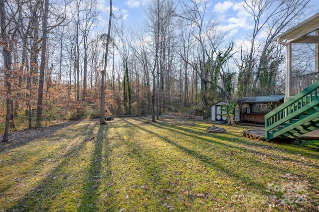 view of yard with a storage unit and a wooden deck