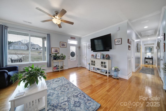 living room featuring hardwood / wood-style flooring, crown molding, and ceiling fan