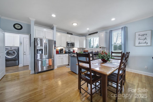 dining room with crown molding, washer / dryer, and light wood-type flooring