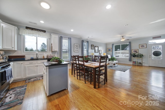 kitchen featuring white cabinetry, crown molding, and a center island