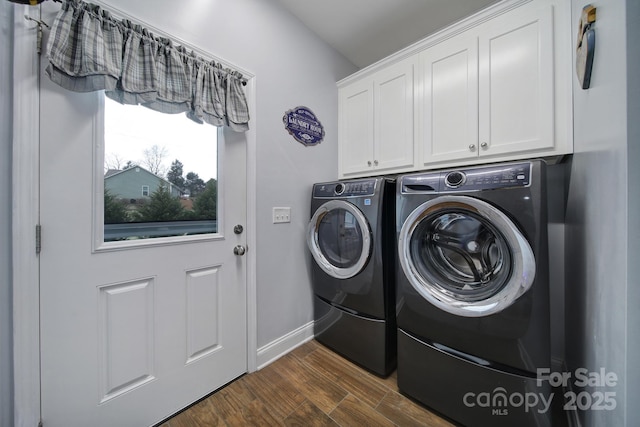 laundry room with cabinets, dark hardwood / wood-style flooring, and washer and clothes dryer