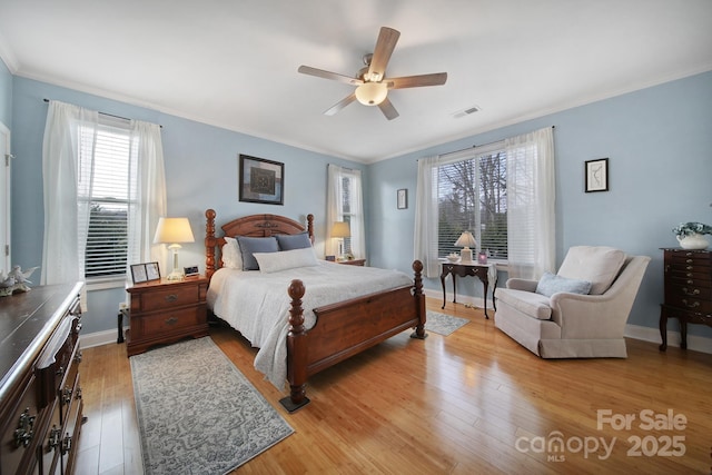 bedroom with ornamental molding, light hardwood / wood-style floors, and ceiling fan