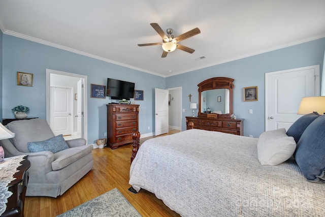 bedroom with crown molding, ceiling fan, and light wood-type flooring