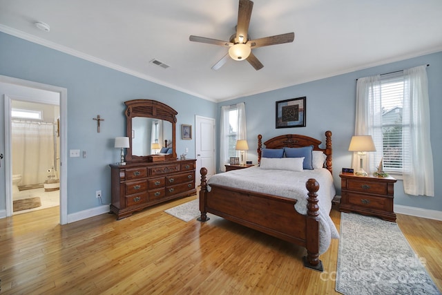 bedroom with ornamental molding, ensuite bathroom, ceiling fan, and light wood-type flooring