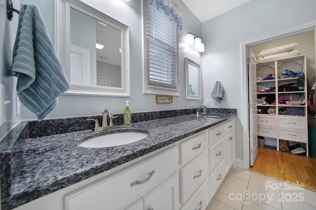 bathroom featuring tile patterned flooring and vanity