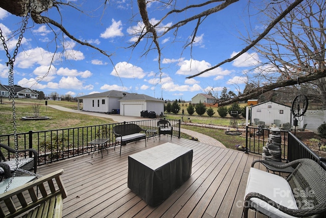 wooden terrace featuring a lawn