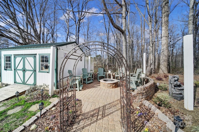 exterior space featuring a shed and an outdoor fire pit