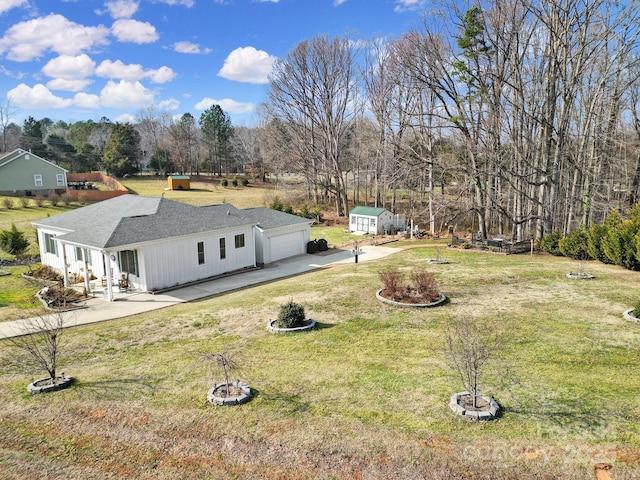 exterior space featuring a garage and a lawn