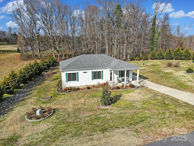 view of front of house with a front yard and covered porch