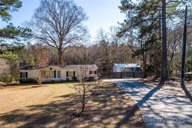 ranch-style home with a front lawn